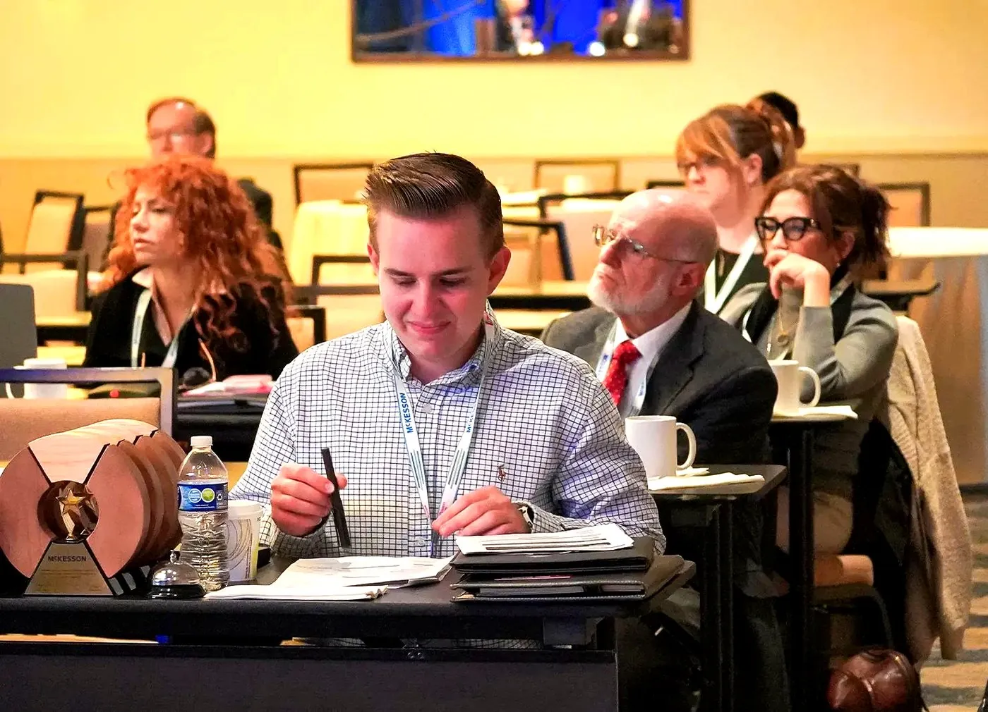 A delegate taking notes during a talk